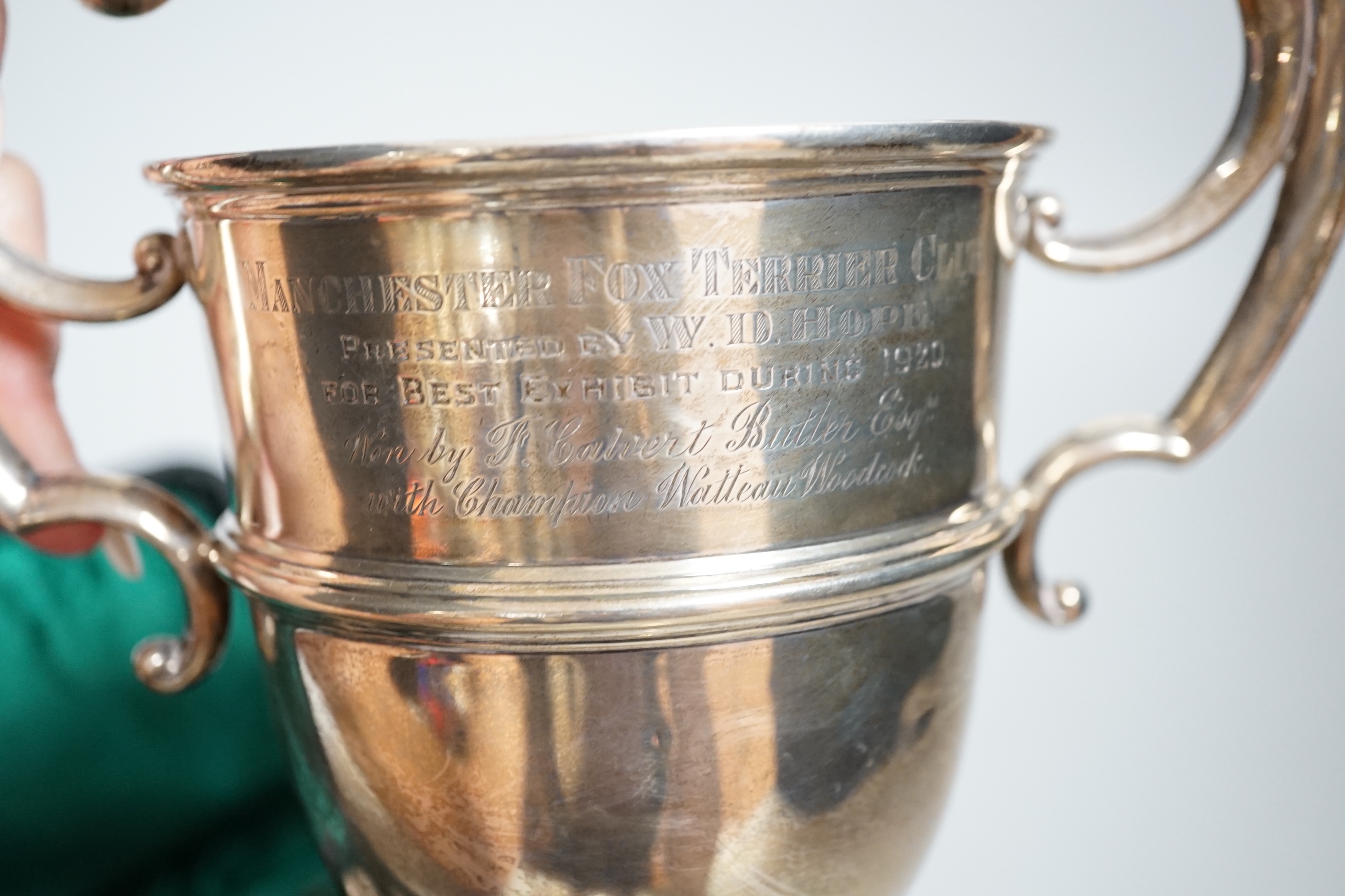 A George V silver two handled presentation cup, William Neale & Sons, Birmingham, 1920, 19.2cm, 9.2oz and a cased silver mounted necessaire set.